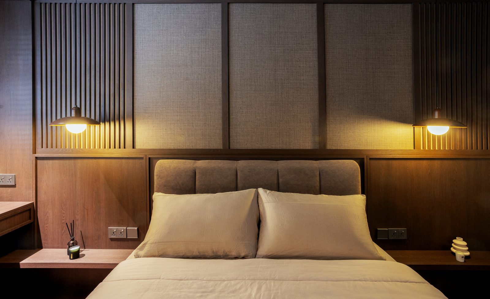 Master bedroom with bespoke timber headboard wall and pendant lights