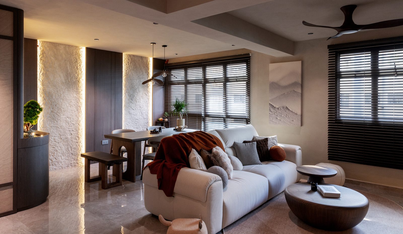 Living room with wabi-sabi stone columns and warm ambient lighting
