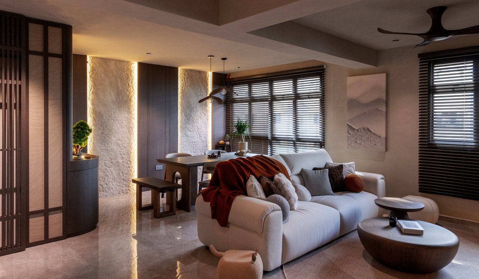 Living and dining area with Japanese stone feature wall and arched screen