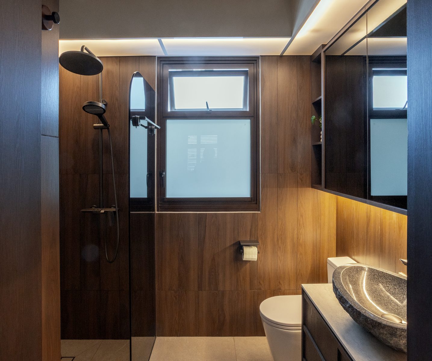 Common bathroom with dark timber tiles, rain shower, and stone basin
